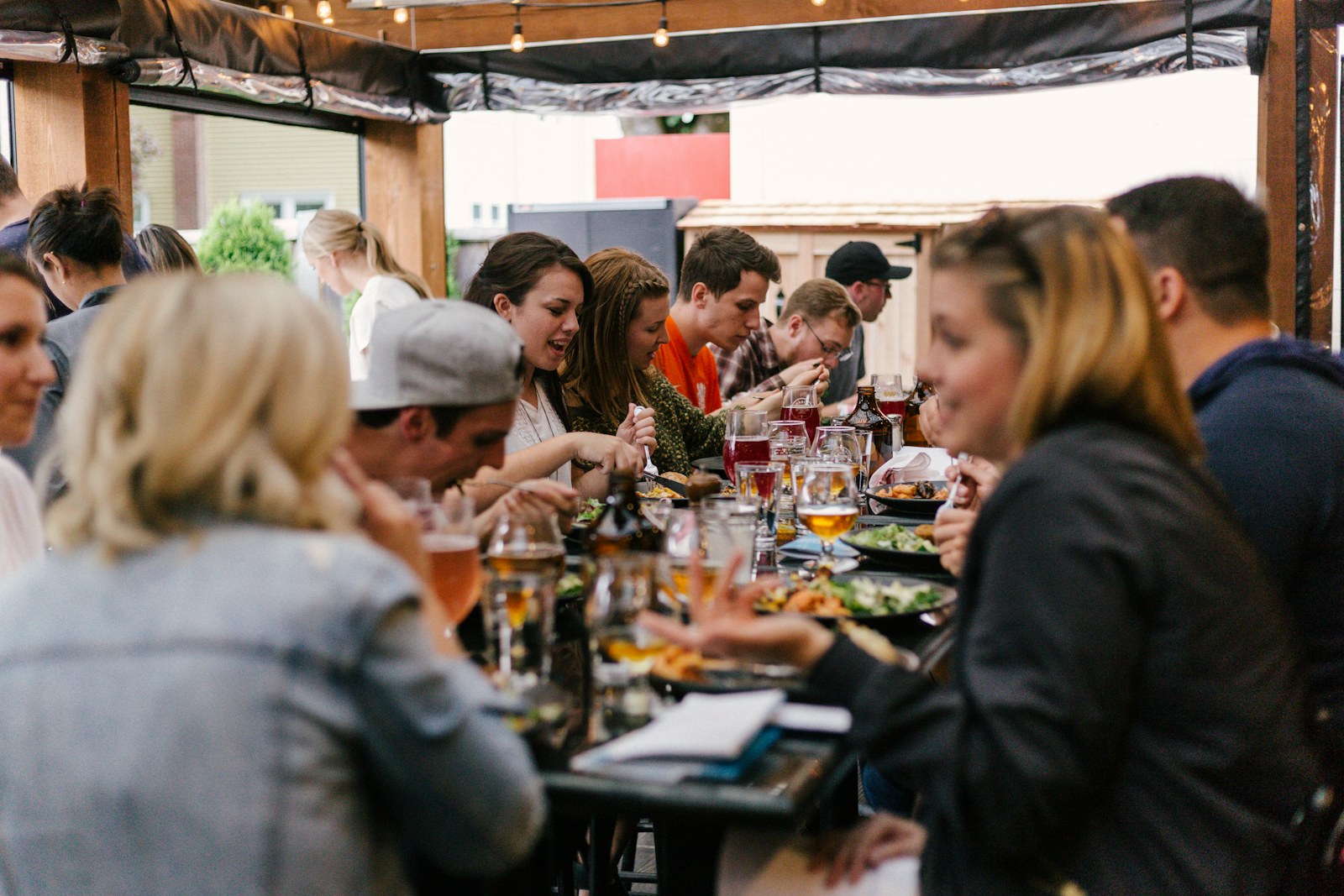 Friends sharing food around a long table